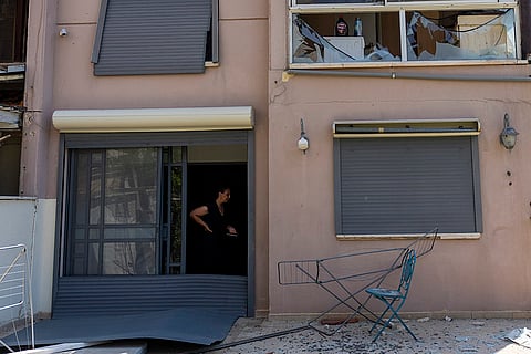 Middle East Tensions: A woman stands in a damaged house following an attack from Lebanon